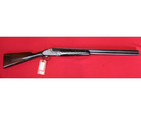 A 12 bore O/U shotgun by Merkel, S/No.58938, 28" barrels with good bores, this is a '303' model with fully engraved action, t