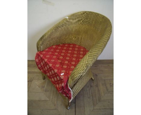 Lloyd Loom style gold coloured armchair 