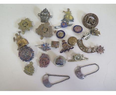 A collection of approximately 20 military cap badges with some enamel regimental badges, ranging from WWI onwards, including 