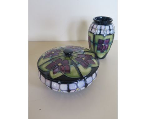 A Moorcroft Violet pattern trinket box, 12cm diameter, and vase, 10.5cm high, with some crazing and damage to the side decora