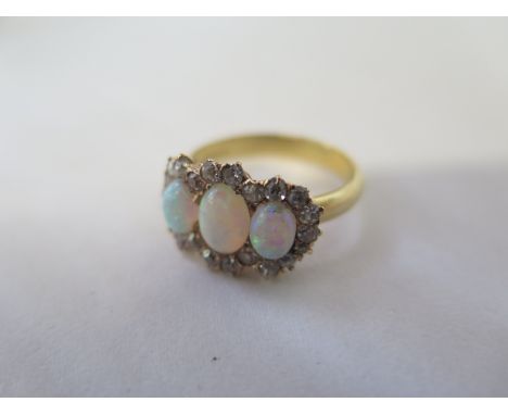 An 18ct three stone opal and diamond cluster ring - size Q - approx 5.3 grams - small flaw to one opal otherwise generally go