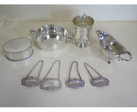 A collection of silver items including a silver sauceboat, a small tankard, taste du vin, a trinket box together with four sp