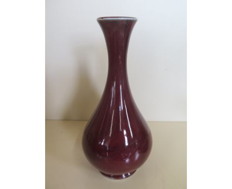 An experimental stoneware Moorcroft sang de boeuf vase, approximately 23cm high, without box, with some flaws to its glaze 