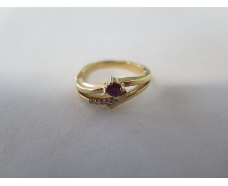 An 18ct ruby and diamond ring - size K - approx 4.5 grams - generally good, some usage 