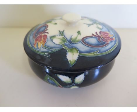 A 2003 Moorcroft lidded pot, approximately 12.5 cm diameter, without box, in good condition 