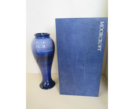 A Moorcroft blue trial vase - 28cm tall - good condition, boxed 