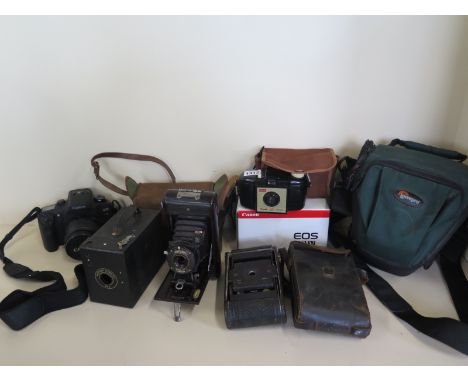A Canon EOS 33V 35mm camera and four vintage cameras 