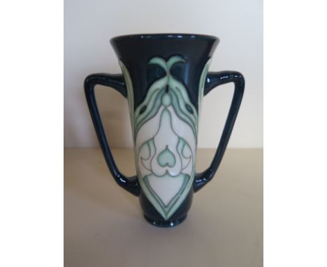 A 1994 Moorcroft MCC loving cup with snowdrop pattern, approximately 15cm high, with original box and in good condition 