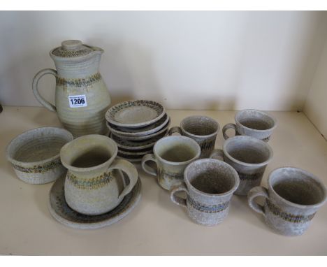 A contemporary rough glazed, ceramic coffee service by an Irish Potter, each piece signed, a coffee pot, milk jug, six cups, 