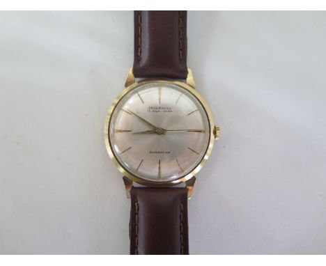 An Ingersol 9ct gold gents wristwatch - manual wind - 34mm wide including button - working order - new strap, clean condition