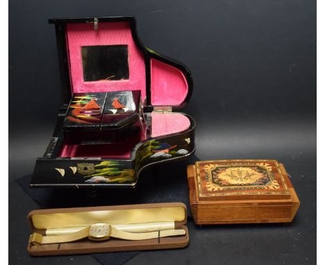 A 1960's clockwork musical jewellery box, as a piano, black lacquered, painted with Japanese landscape; another, inlaid; a Mo