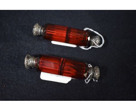 A Victorian silver mounted faceted ruby glass double ended  scent bottle, 9.5cm long, c.1870;  another  (2)