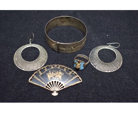 A Siamese niello fan brooch; a bangle Charles Horner, Chester, 1946; an enamelled frog ring; etc