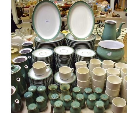 An Extensive Denby pottery green pottery table service, comprising coffee pots, tea pots, saucers, serving bowls, dinner plat