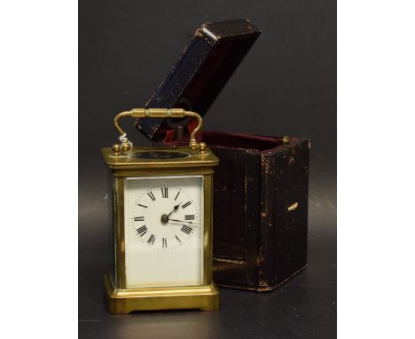 A French lacquered brass carriage clock, white enamel dial with Roman numerals, Morocco case, c.1920