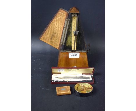 A French metronome; a silver plated yard 'o lead pencil, boxed; a Victorian papier-maché snuff box, printed with a landscape;