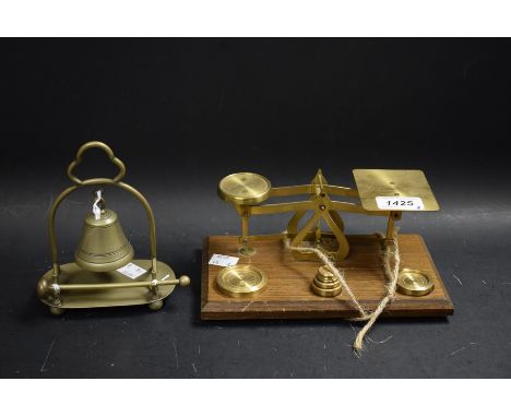 A pair of brass postal scales, with graduated brass weights; a brass desk bell (2)