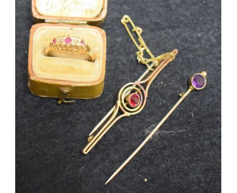 An 18ct gold diamond and ruby chip ring, 2g; a target brooch; an amethyst set stick pin (3)