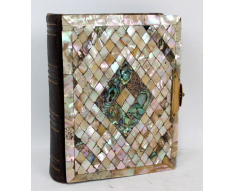 A Victorian mother and pearl and brass mounted photograph album containing portraits, etc, width 13cm. CONDITION REPORT: Ther