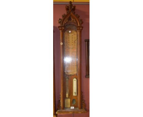 A late Victorian oak Admiral Fitzroy's barometer, with Gothic carved pediment above paper dial, thermometer and storm class i