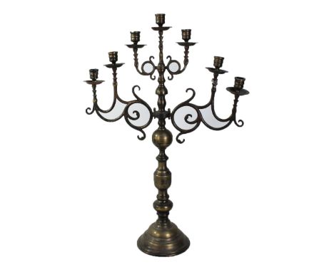 A large brass seven light candelabrum with turned central column on spreading circular base, height 76cm.