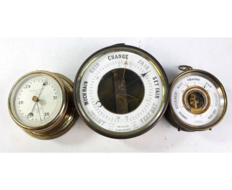 A brass cased circular metallic barometer, diameter 17cm, an aneroid barometer inscribed 'T Wheeler Scientific Inst Ltd, Lond