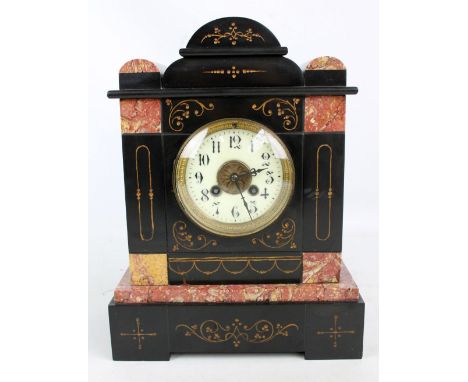 A 19th century French pink marble and slate eight day mantel clock, the shaped domed top above a circular dial set with Arabi