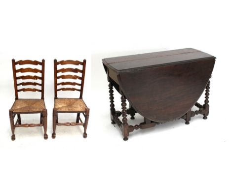 A set of six 19th century wavy ladder back ash rush seated Country Made chairs, and an oak dropleaf table (7).