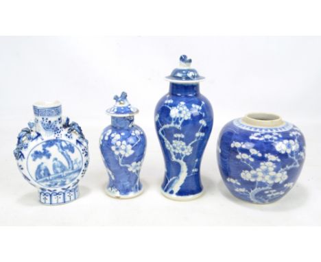 A late 19th century Chinese porcelain baluster vase and cover painted in underglaze blue with blossoming tree decoration, Kan