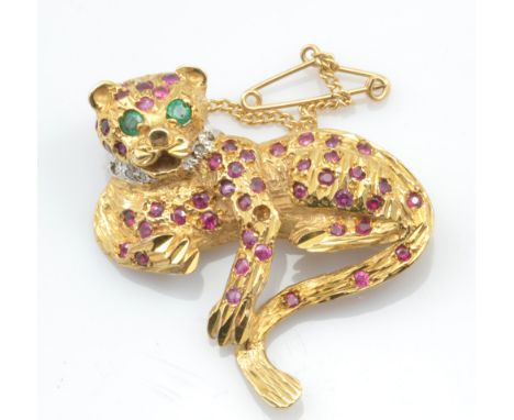 A 9ct yellow gold ruby, diamond and emerald set brooch modelled as a leopard, width 4cm, approx 12g. CONDITION REPORT: Appear