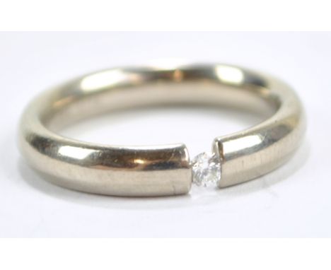 An 18ct white gold diamond solitaire ring with tension set stone, size P, approx 7.2g.