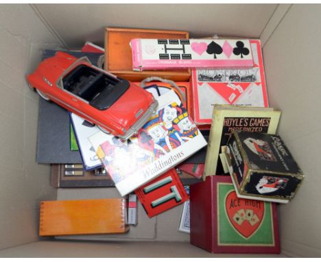 A group of various games to include Monopoly, Chess and Bezique, also a cribbage board and a toy car.