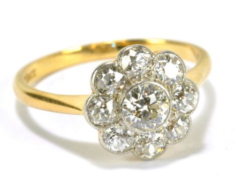 An 18ct yellow gold and diamond daisy cluster ring, the central stone weighing approx. 0.5cts, size R, approx 3.9g, with insu