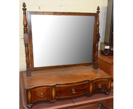 An Edwardian mahogany swing frame toilet mirror with three drawer serpentine base and bun feet, width 54cm.