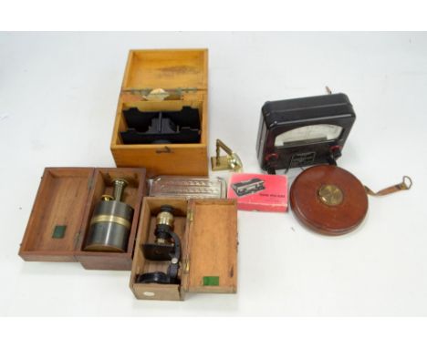 An early 20th century black lacquered field microscope by C. Baker of London, a John Rabone &amp; Sons 'Rigida' tape measure,