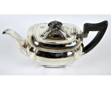 A George V hallmarked silver teapot of rounded rectangular form, Sheffield 1934, length 27cm, approx 21.5ozt.