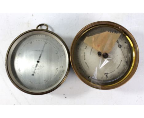 A late 19th century circular brass barometer with silvered dial inscribed 'T Wheeler, 217, Goswell Rd, London, No.3051', diam