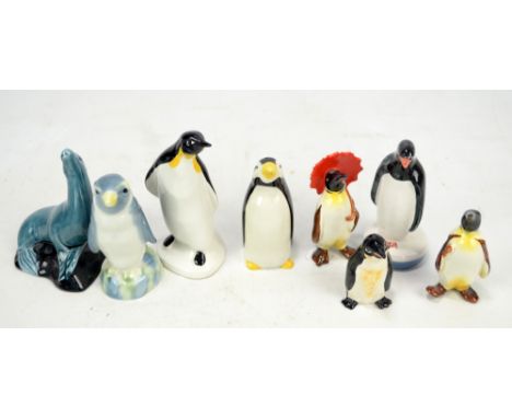 Six figures of penguins including Beswick, Poole and Carlton Ware examples, also a Poole figure of a sea lion (7).