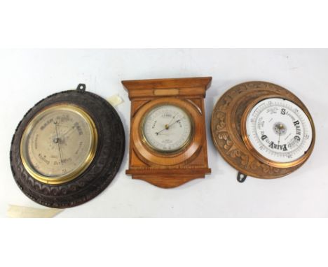 An early 20th century carved oak cased circular barometer with silvered dial inscribed 'Archer &amp; Sons, Lord Street, Liver