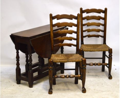 An oak dropleaf table and set of four ladder back chairs (5).