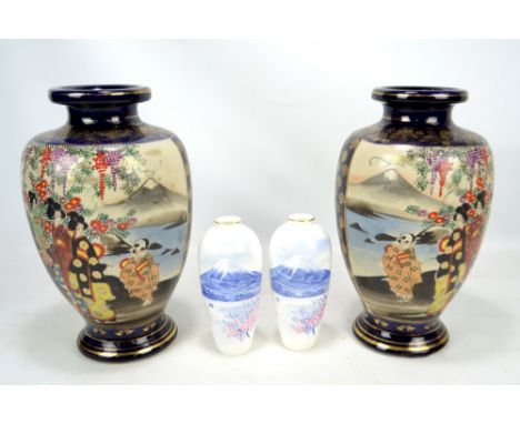 A pair of Japanese ceramic vases with figural landscape decorated panels and gilt foliate detail, both with three character m