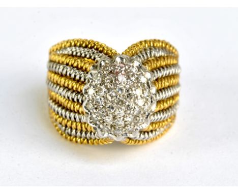 An 18ct yellow and white gold diamond set broad ring, size H1/2, approx 9.5g.