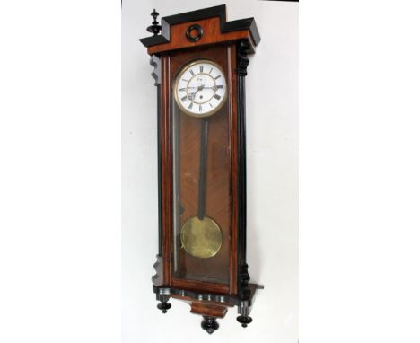 A circa 1900 walnut beech and ebonised Vienna style wall clock with two-piece white enamel dial set with Roman numerals, leng