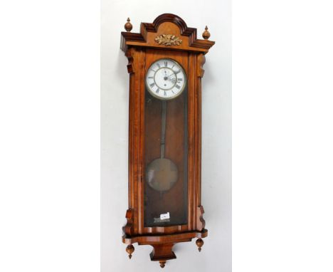 A circa 1900 walnut and beech Vienna style wall clock with two-piece white enamel dial set with Roman numerals, single brass 