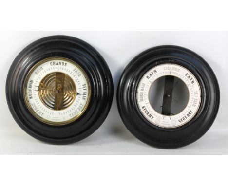 An ebonised circular metallic barometer, diameter 33cm, and another similar example (lacking bezel and glass), diameter 31.5c