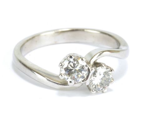 An 18ct white gold and diamond two stone crossover ring, each stone weighing approx 0.3ct in claw setting, clarity SI1, colou