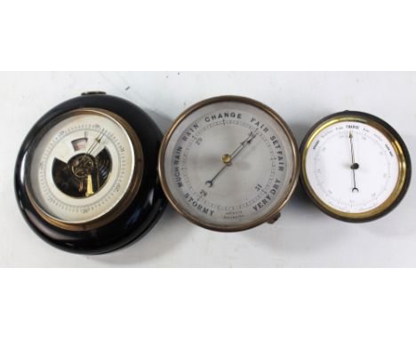 A brass cased circular aneroid barometer with silvered dial, diameter 15cm, a circular barometer with white enamel dial, diam