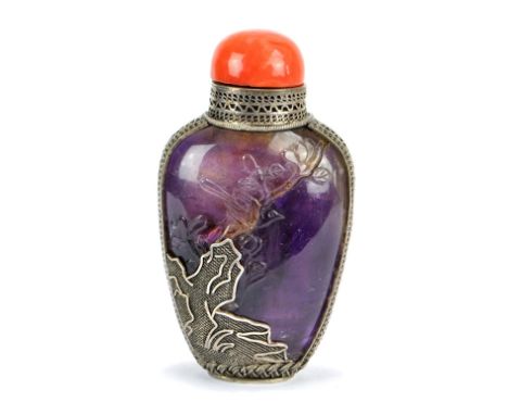 A 19th century Chinese amethyst snuff bottle, carved in low relief with peony flowers and birds, and with external silver fil