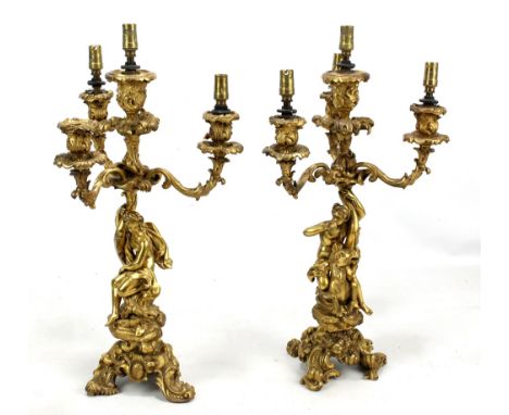A pair of 19th century ormolu figural candelabra with three foliate scroll branches and central light, on cast floral and fol