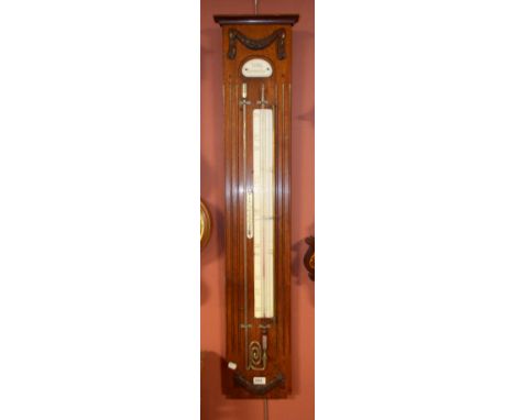 An oak backed contra-barometer with applied carved detail and thermometer, height 118cm.